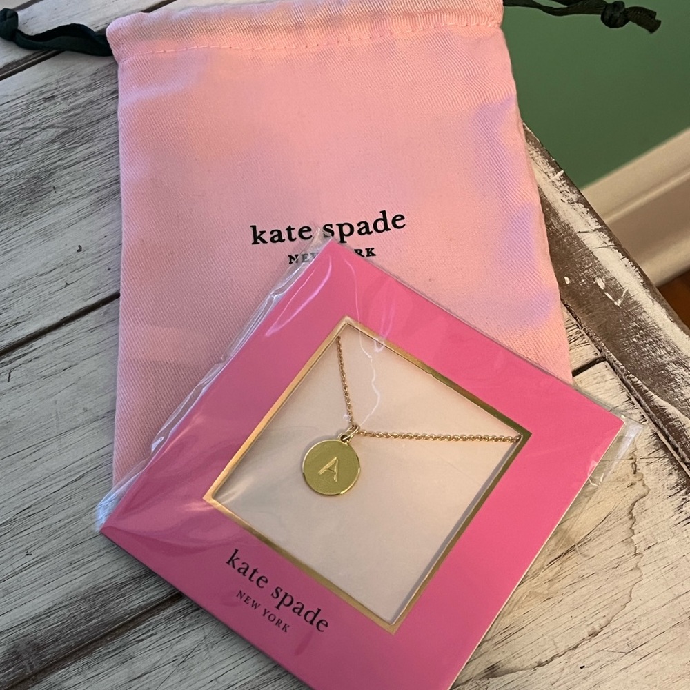 kate spade gold pendant with pink pouch